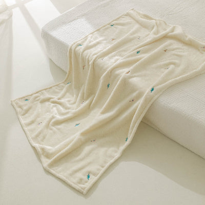 couverture bébé beige en velours avec dinosaures